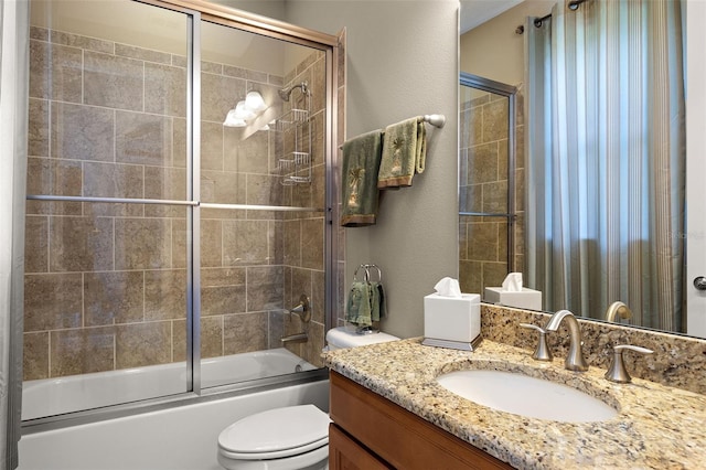 full bathroom with vanity, shower / bath combination with glass door, and toilet