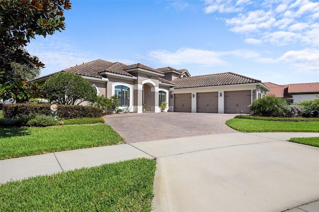 mediterranean / spanish-style house featuring a garage and a front lawn