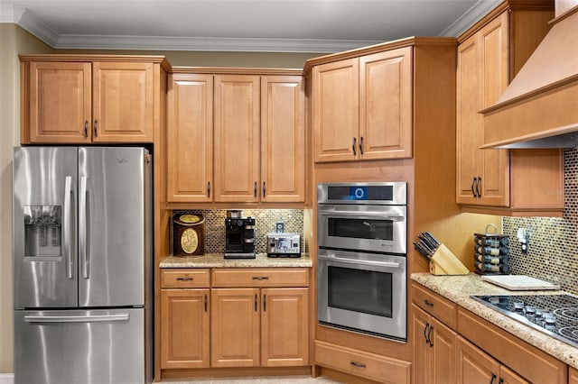 kitchen featuring premium range hood, appliances with stainless steel finishes, backsplash, and crown molding