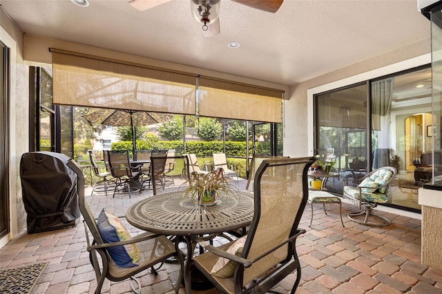 sunroom featuring ceiling fan