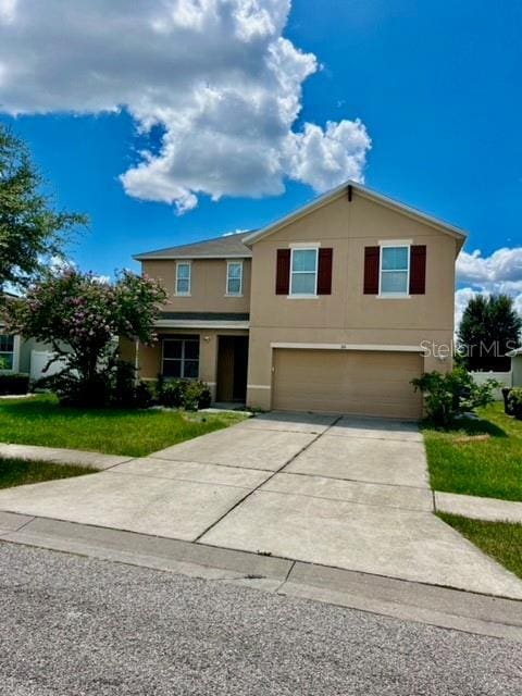 view of front of house featuring a garage and a front lawn