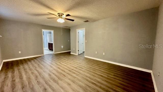 spare room featuring hardwood / wood-style flooring, a textured ceiling, and ceiling fan