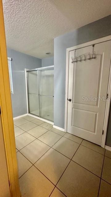 bathroom featuring tile patterned floors and a textured ceiling