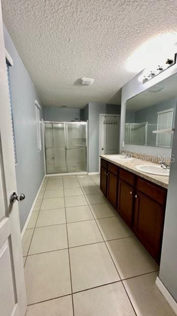 bathroom featuring vanity, walk in shower, and tile patterned flooring