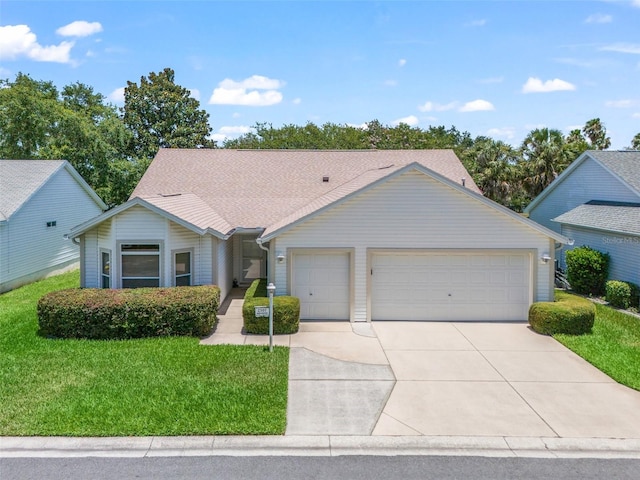 single story home featuring a garage and a front yard