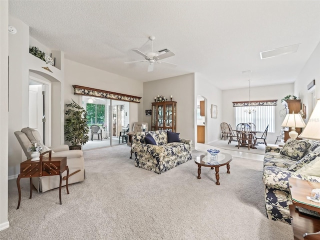 carpeted living room featuring a textured ceiling and ceiling fan