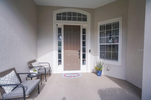 32313 Oak Canopy Dr, Sorrento, FL 32776 - doorway to property with stucco siding and a porch