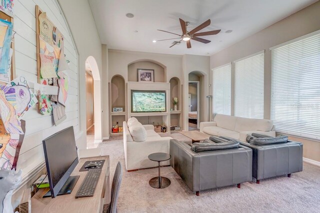 living room featuring light carpet and ceiling fan