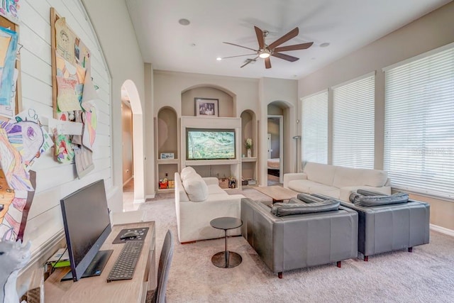32313 Oak Canopy Dr, Sorrento, FL 32776 - living room with arched walkways, baseboards, a ceiling fan, and carpet floors
