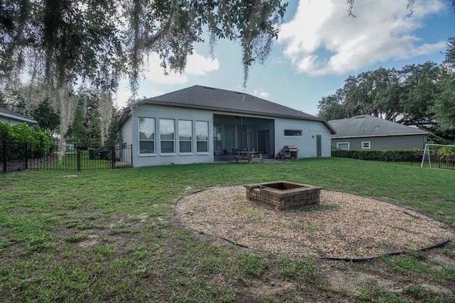 32313 Oak Canopy Dr, Sorrento, FL 32776 - back of house with a fire pit, a shingled roof, a lawn, and fence