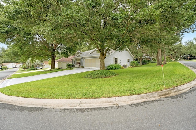 view of front of home with central AC unit, driveway, an attached garage, and a front lawn