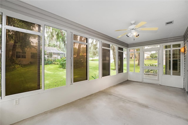 unfurnished sunroom featuring visible vents and ceiling fan