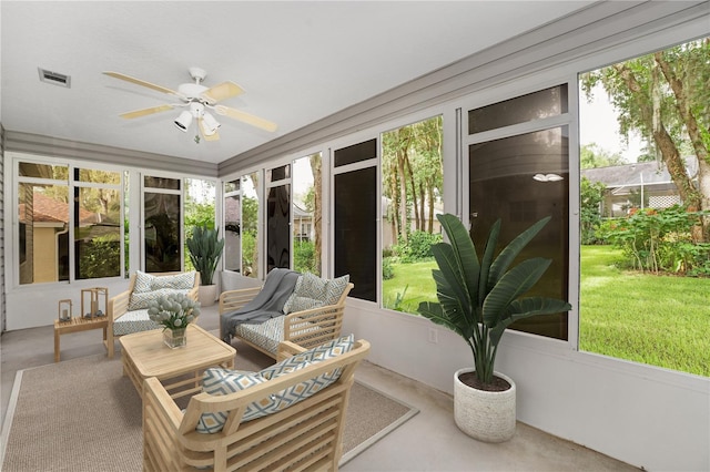 sunroom / solarium featuring ceiling fan