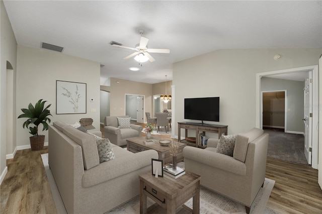 living area featuring visible vents, baseboards, and wood finished floors