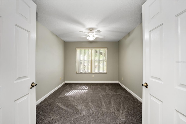 unfurnished room featuring baseboards, a ceiling fan, dark colored carpet, and a textured ceiling