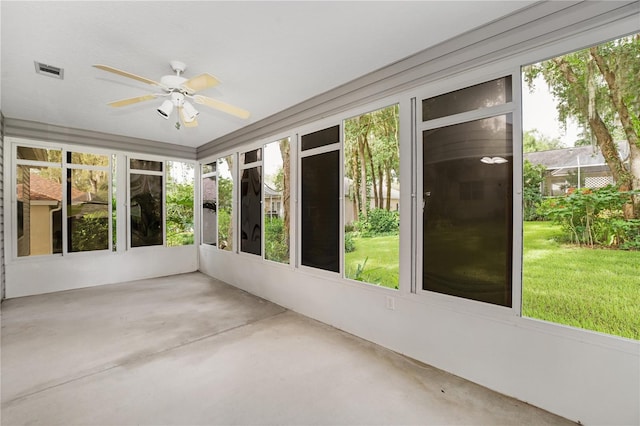 unfurnished sunroom featuring ceiling fan