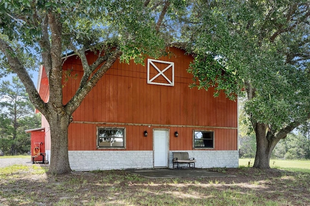 back of house with an outbuilding