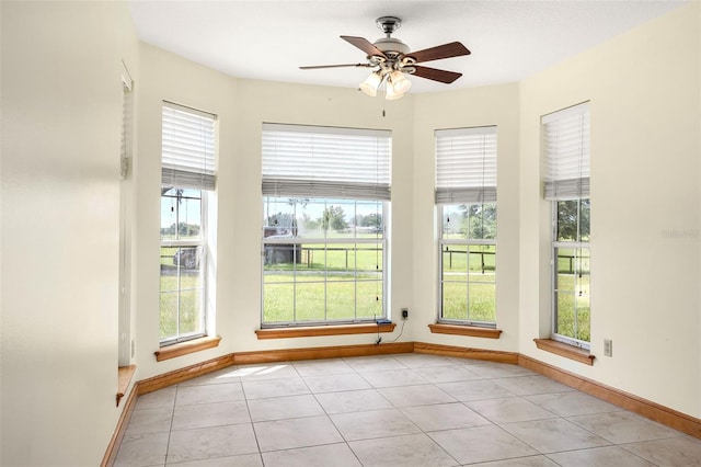 unfurnished sunroom featuring ceiling fan