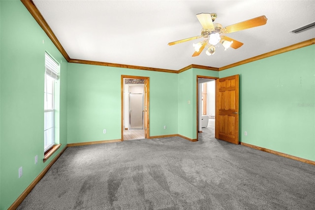 empty room with ceiling fan, ornamental molding, and carpet flooring