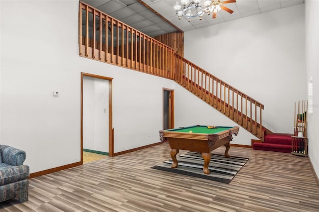 playroom with a paneled ceiling, billiards, wood-type flooring, and a high ceiling