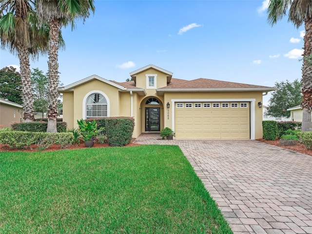 view of front of home with a garage and a front lawn