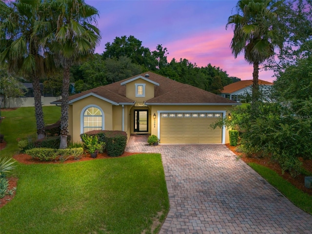 view of front facade with a lawn and a garage