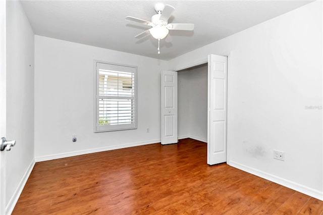 unfurnished bedroom with ceiling fan and hardwood / wood-style floors