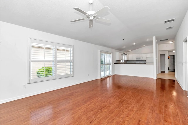 unfurnished living room with lofted ceiling, ceiling fan, and hardwood / wood-style floors