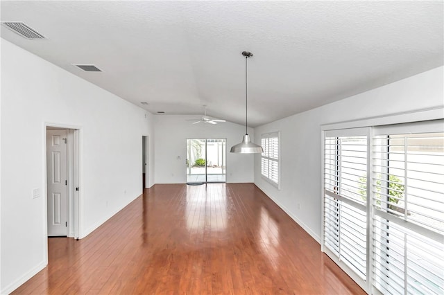 unfurnished room with ceiling fan, a textured ceiling, vaulted ceiling, and wood-type flooring