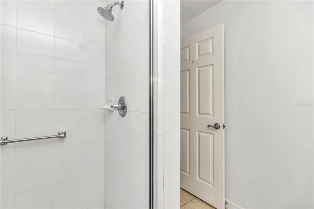 bathroom featuring tile patterned floors and tiled shower