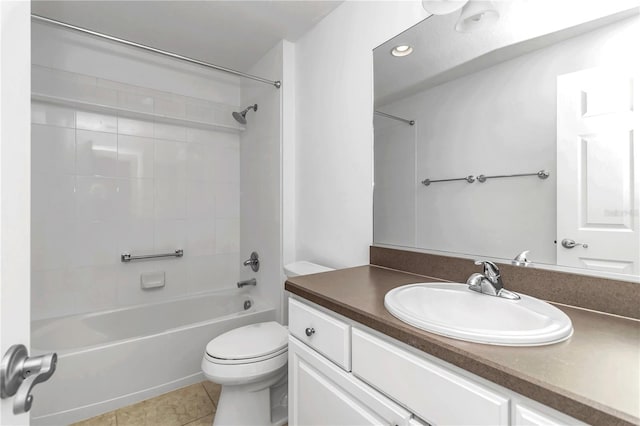 full bathroom with tile patterned floors, tiled shower / bath, vanity, and toilet