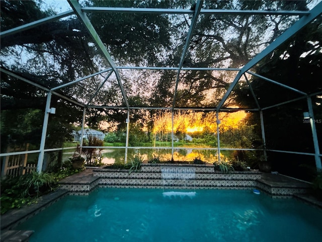 view of swimming pool featuring a lanai