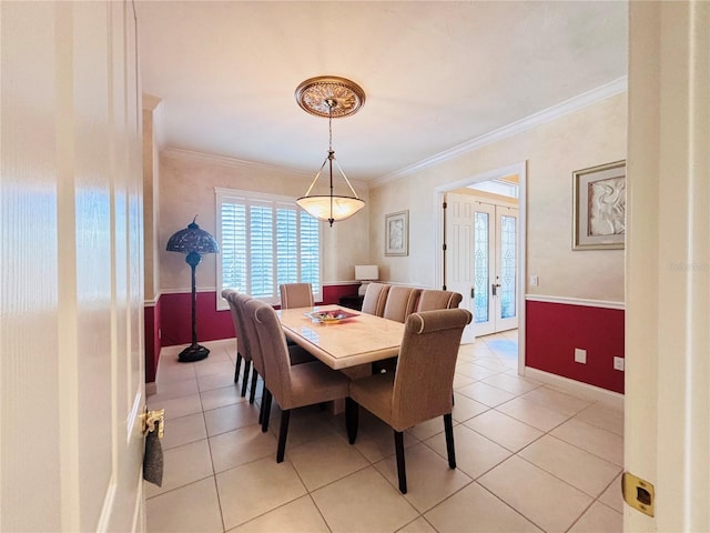 dining room featuring light tile patterned floors, ornamental molding, and french doors