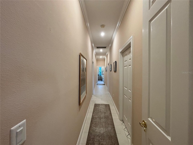 corridor featuring crown molding and light tile patterned flooring