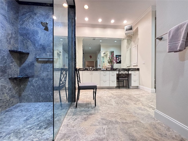 bathroom with vanity, crown molding, and a tile shower