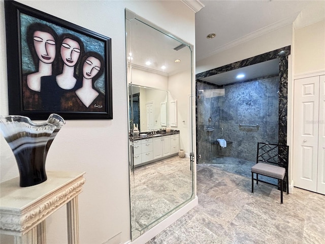 bathroom featuring tiled shower, vanity, and crown molding