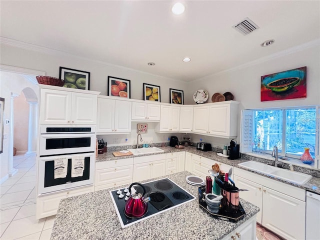 kitchen featuring white cabinetry, sink, white appliances, and crown molding