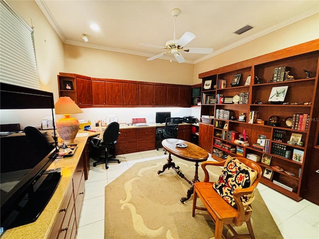 tiled office featuring ceiling fan, crown molding, and built in desk