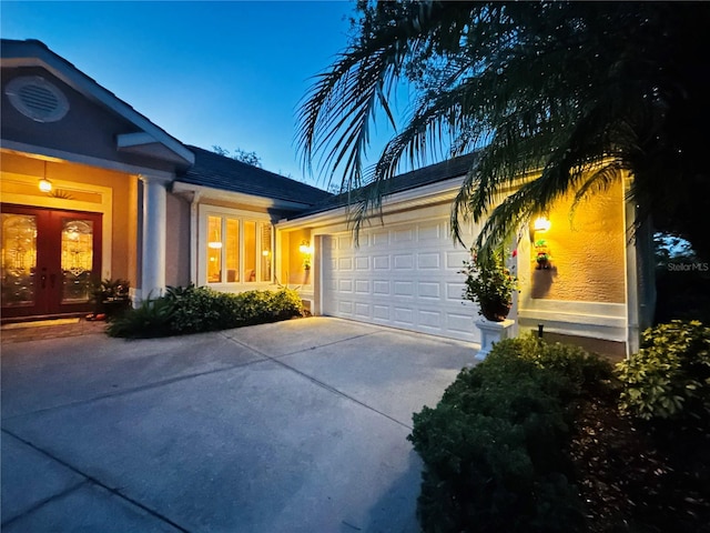 view of front of house with french doors and a garage