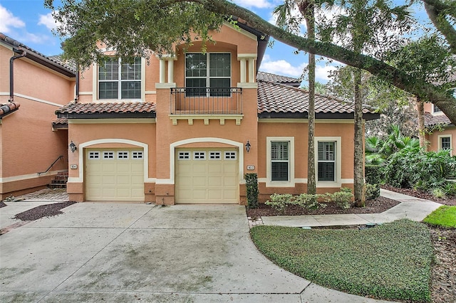 mediterranean / spanish-style home with a garage