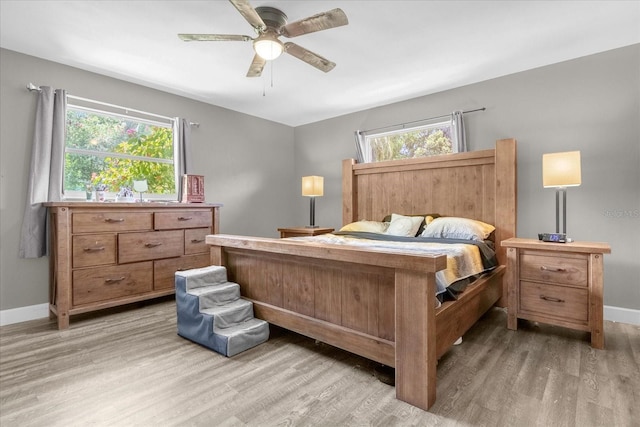 bedroom with ceiling fan and light hardwood / wood-style floors