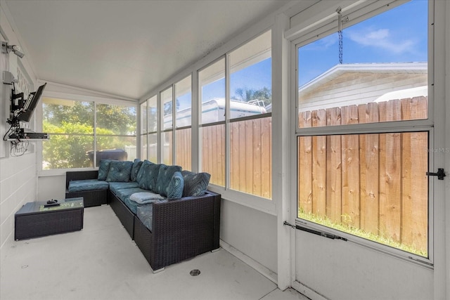 sunroom / solarium featuring vaulted ceiling and plenty of natural light