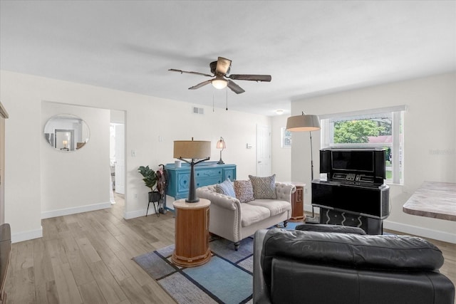 living room featuring ceiling fan and light wood-type flooring