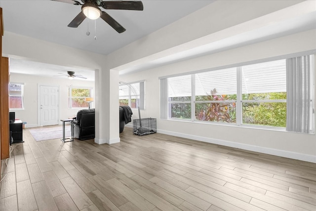 unfurnished living room with light hardwood / wood-style floors and ceiling fan