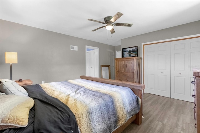 bedroom featuring hardwood / wood-style floors, a closet, and ceiling fan