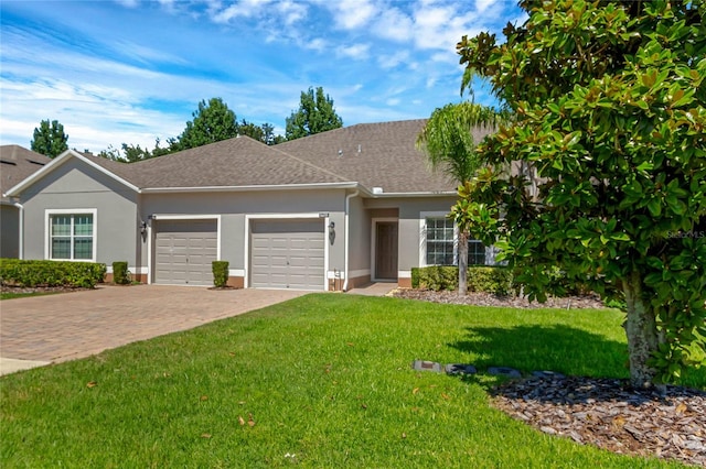 ranch-style house featuring a garage and a front lawn