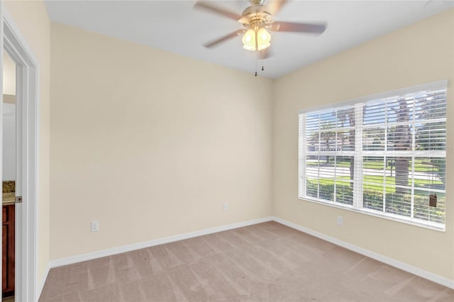 spare room featuring carpet flooring and ceiling fan