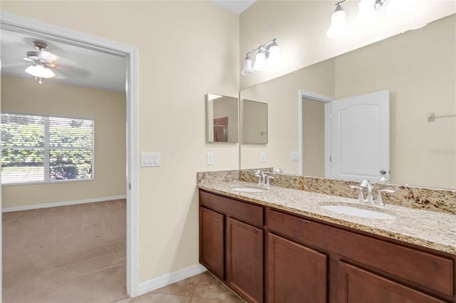 bathroom with dual vanity, ceiling fan, and tile patterned floors