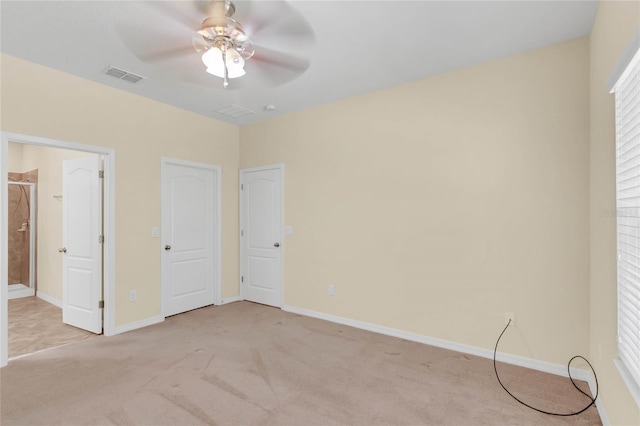 unfurnished bedroom featuring light colored carpet and ceiling fan