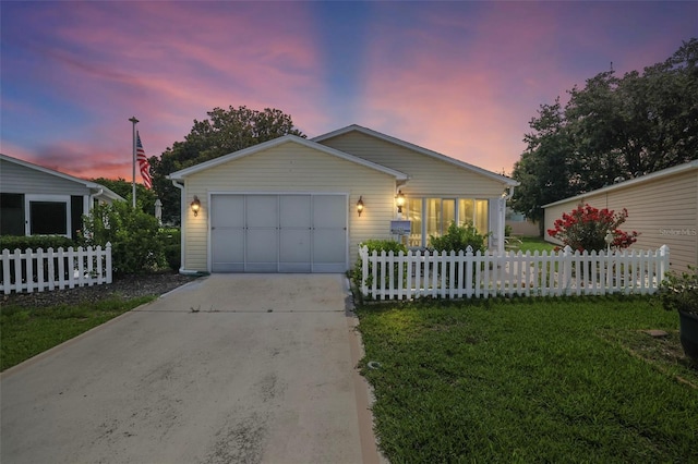 single story home with a yard and a garage